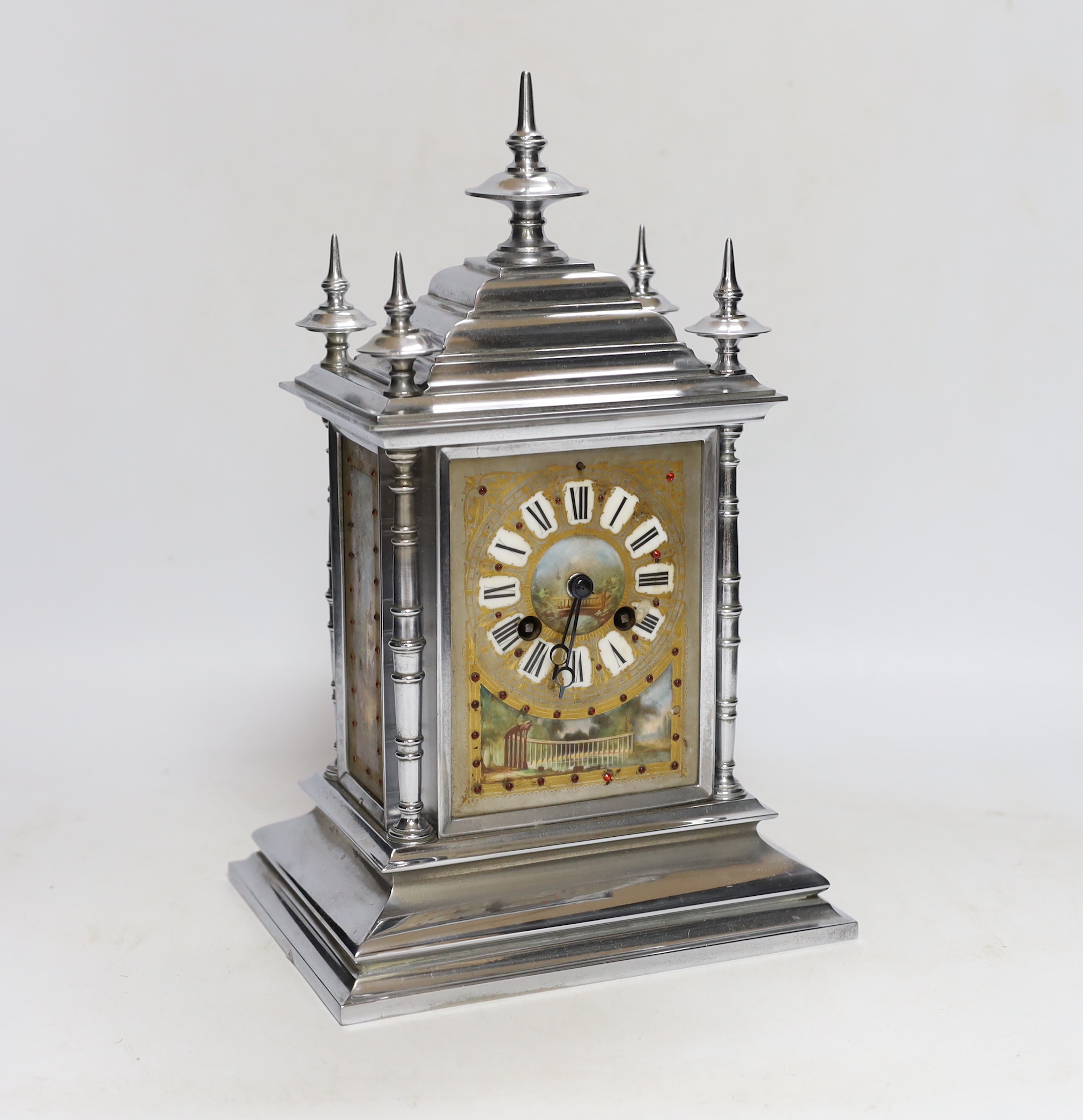 A French chrome plated mantel clock, with jewelled porcelain inset panels 32cm